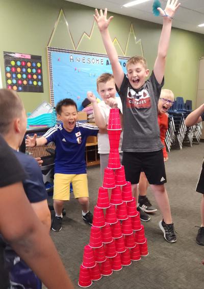 Kids celebrate cup tower