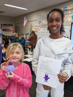 girls pose with art projects