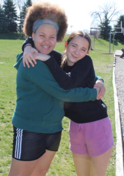 girls hugging outside
