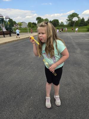 kids playing outsdie with bubbles